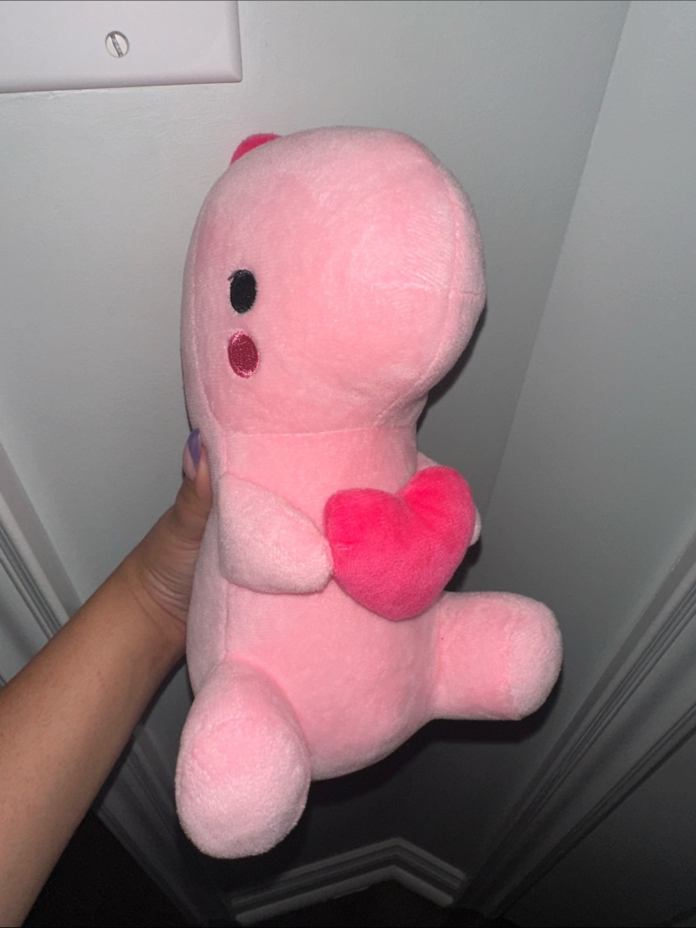 Pink dinosaur plushie